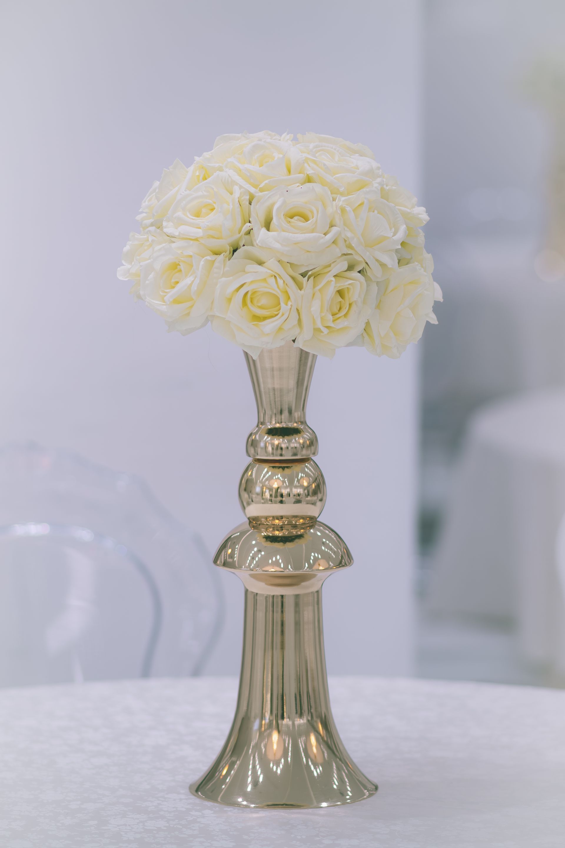 Gold vase with white roses styled for an event